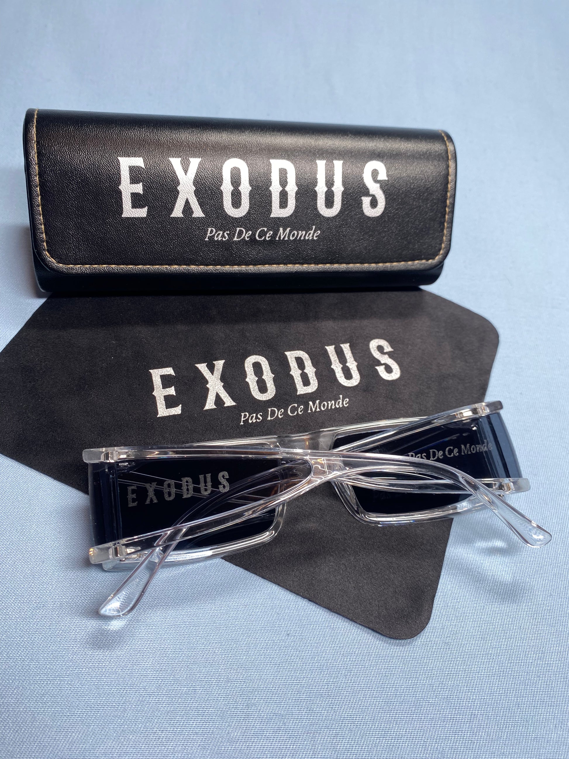 Clothing and accessories from Exodus Pas De Ce Monde – unisex streetwear including t-shirts, jackets, sunglasses, jewelry, bags, and headwear designed for everyday wear and bold urban fashion.