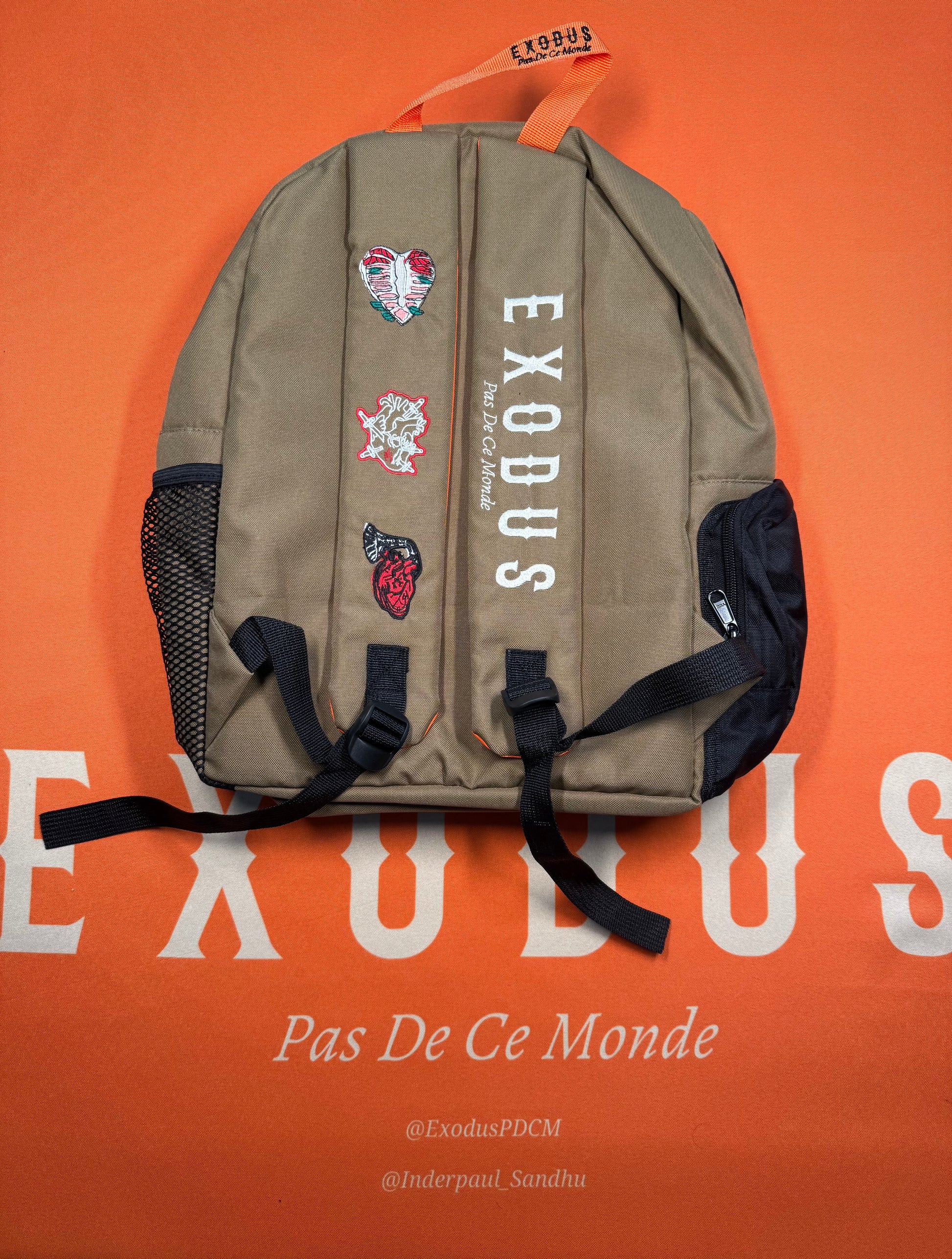 Clothing and accessories from Exodus Pas De Ce Monde – unisex streetwear including t-shirts, jackets, sunglasses, jewelry, bags, and headwear designed for everyday wear and bold urban fashion.