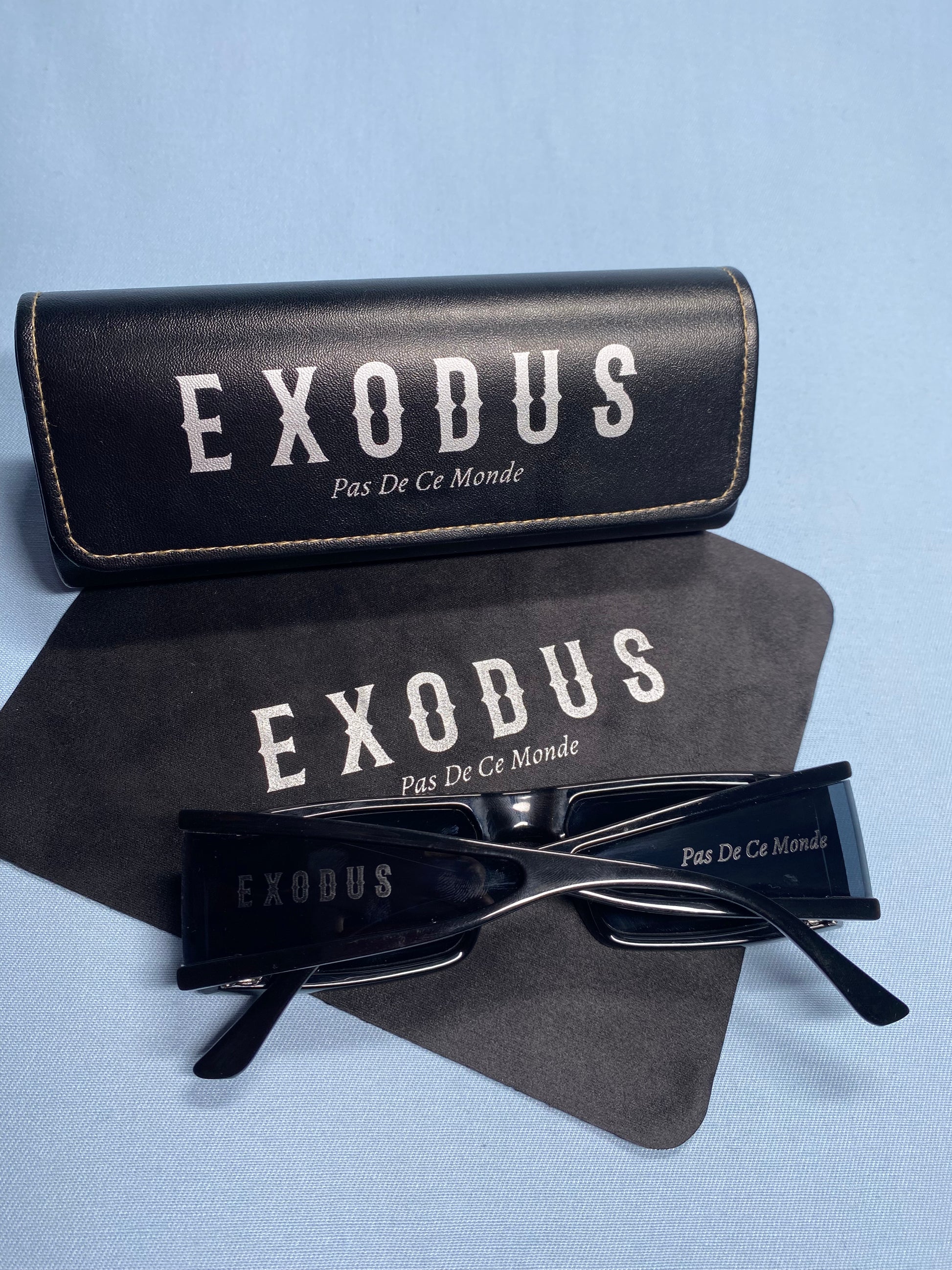 Clothing and accessories from Exodus Pas De Ce Monde – unisex streetwear including t-shirts, jackets, sunglasses, jewelry, bags, and headwear designed for everyday wear and bold urban fashion.