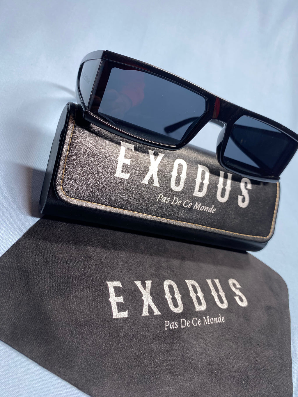 Clothing and accessories from Exodus Pas De Ce Monde – unisex streetwear including t-shirts, jackets, sunglasses, jewelry, bags, and headwear designed for everyday wear and bold urban fashion.