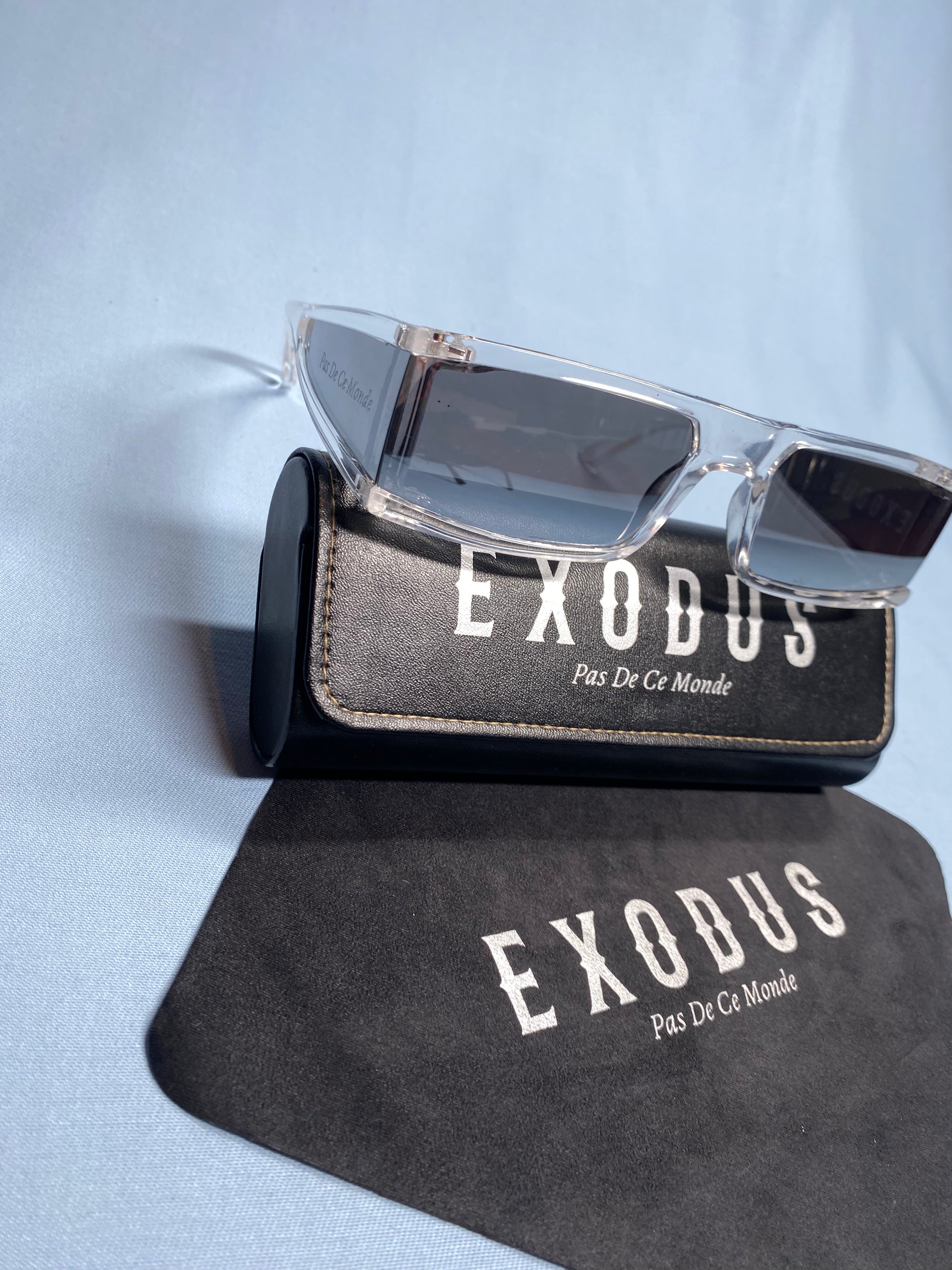 Clothing and accessories from Exodus Pas De Ce Monde – unisex streetwear including t-shirts, jackets, sunglasses, jewelry, bags, and headwear designed for everyday wear and bold urban fashion.