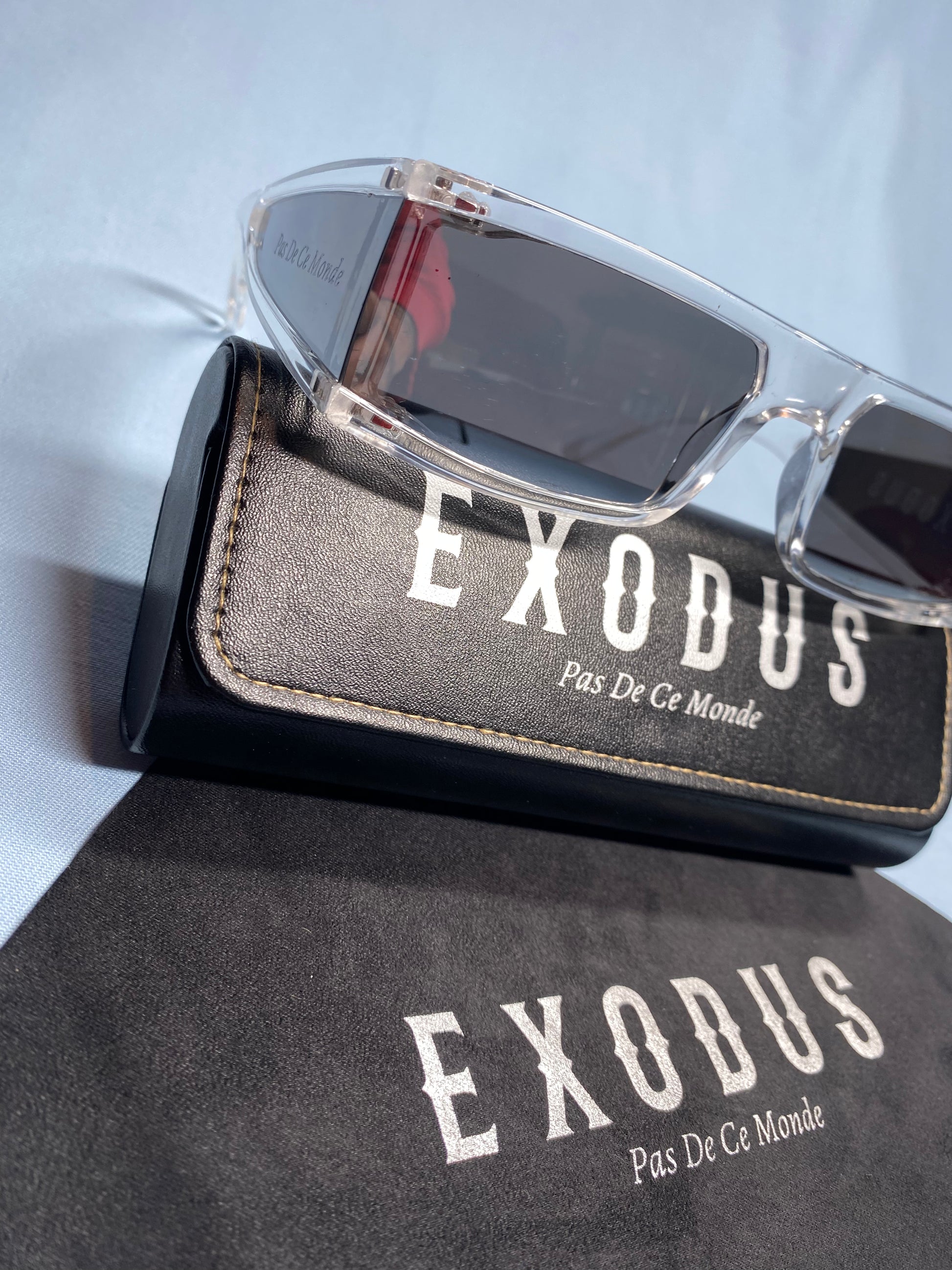 Clothing and accessories from Exodus Pas De Ce Monde – unisex streetwear including t-shirts, jackets, sunglasses, jewelry, bags, and headwear designed for everyday wear and bold urban fashion.