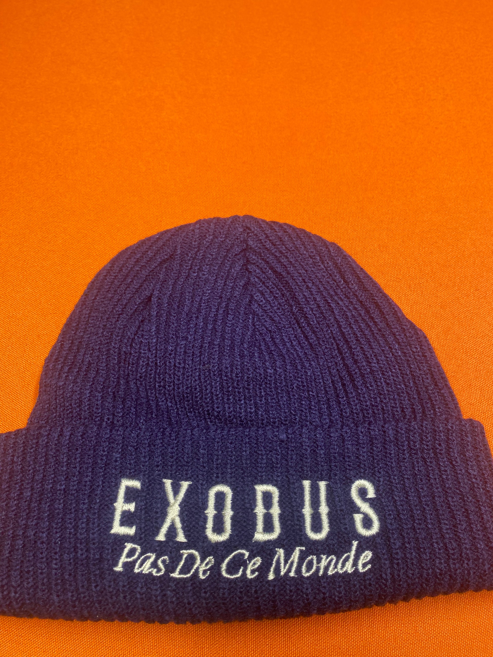 Clothing and accessories from Exodus Pas De Ce Monde – unisex streetwear including t-shirts, jackets, sunglasses, jewelry, bags, and headwear designed for everyday wear and bold urban fashion.