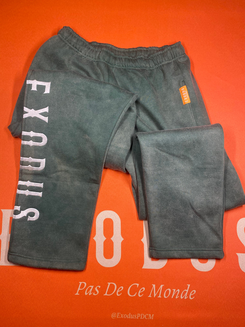 Clothing and accessories from Exodus Pas De Ce Monde – unisex streetwear including t-shirts, jackets, sunglasses, jewelry, bags, and headwear designed for everyday wear and bold urban fashion.