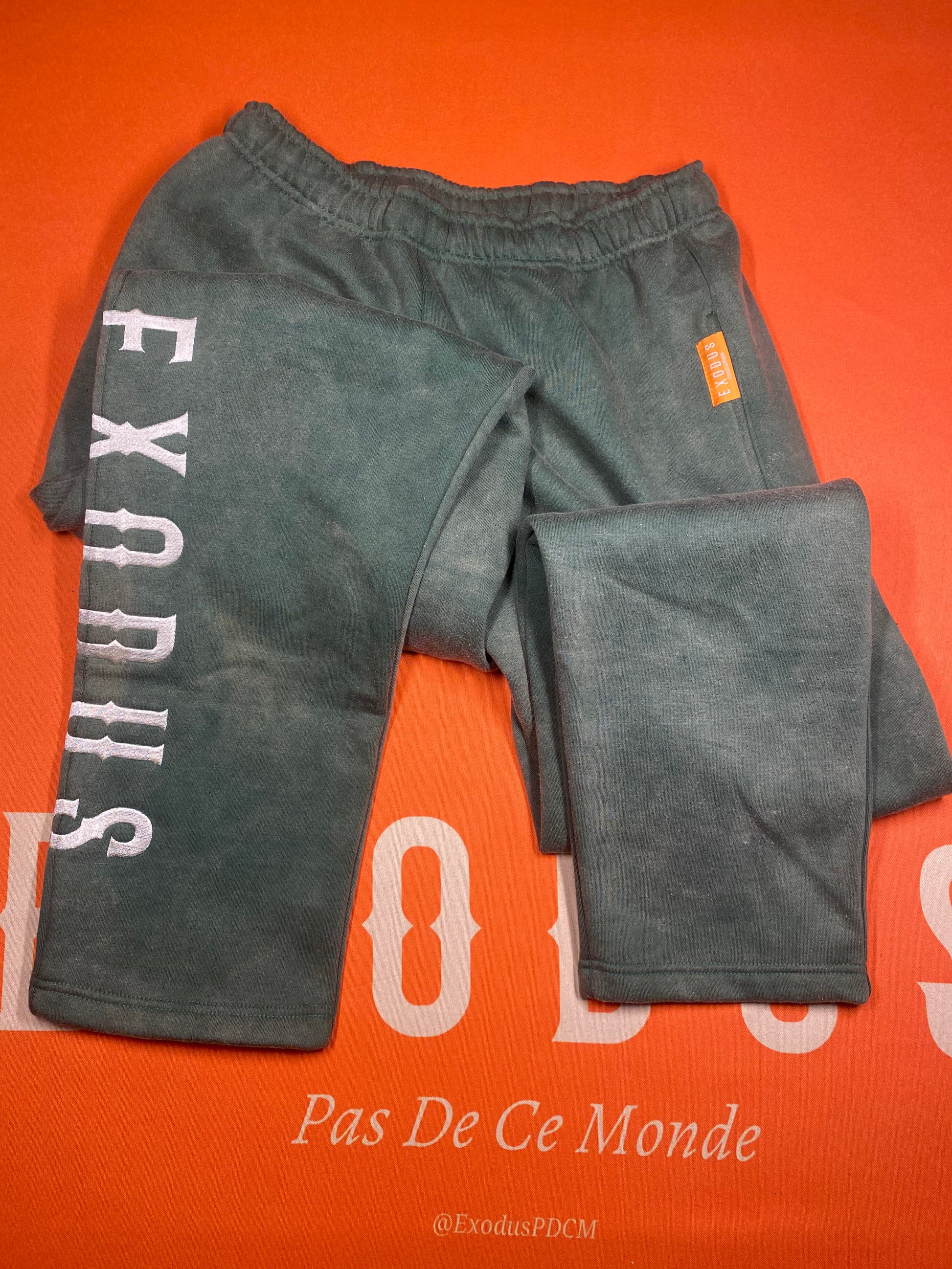 Clothing and accessories from Exodus Pas De Ce Monde – unisex streetwear including t-shirts, jackets, sunglasses, jewelry, bags, and headwear designed for everyday wear and bold urban fashion.