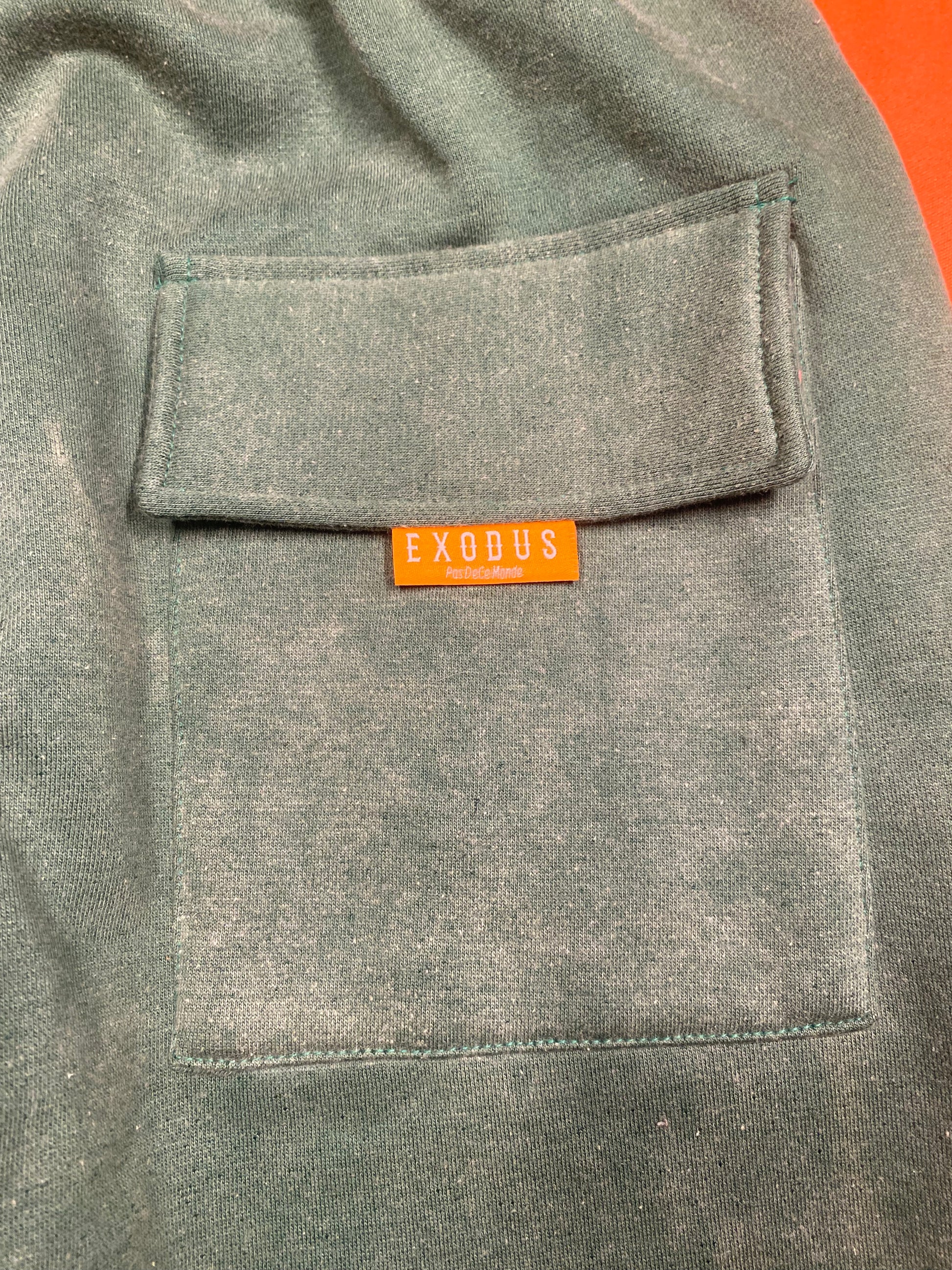 Clothing and accessories from Exodus Pas De Ce Monde – unisex streetwear including t-shirts, jackets, sunglasses, jewelry, bags, and headwear designed for everyday wear and bold urban fashion.
