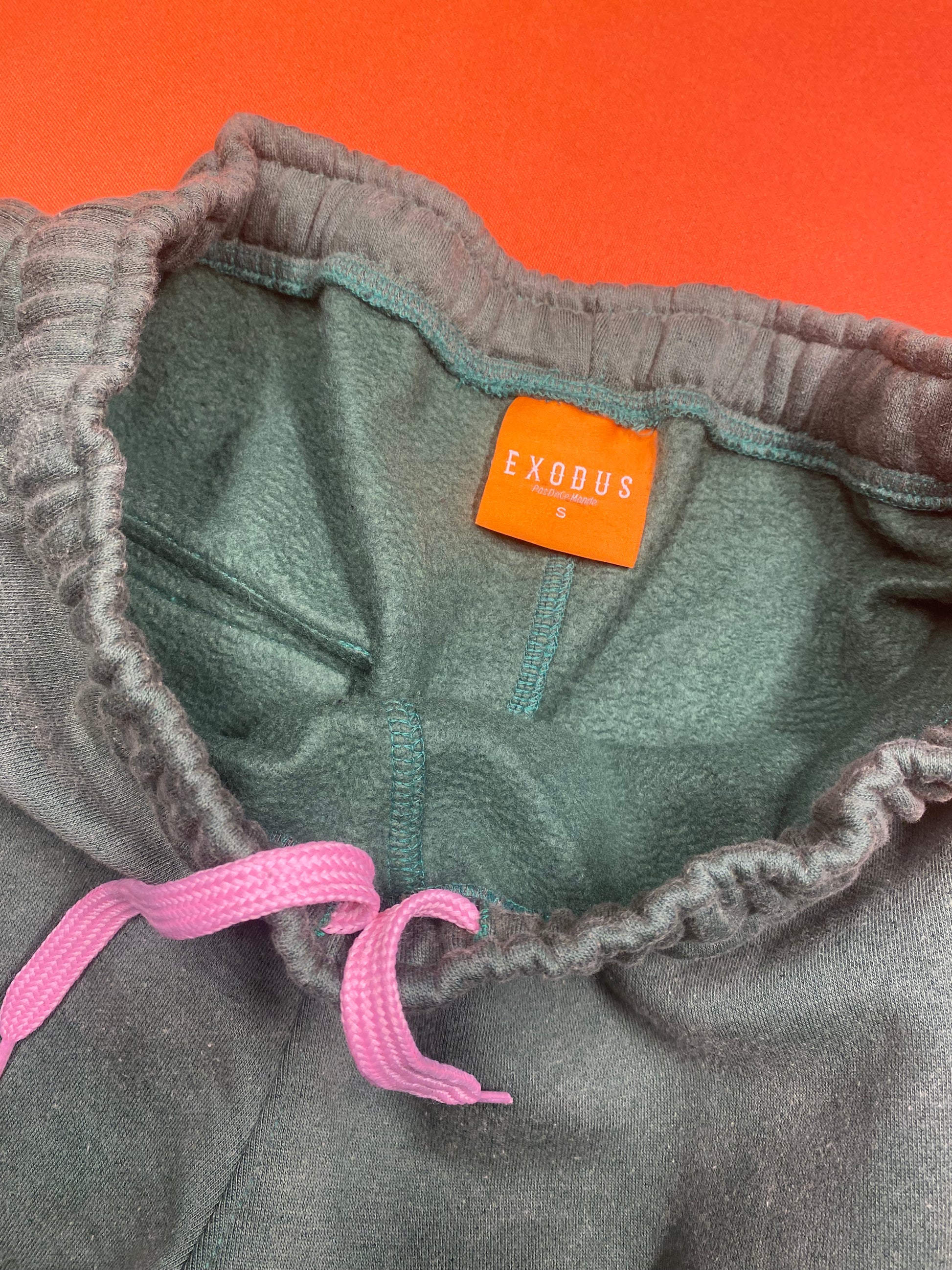 Clothing and accessories from Exodus Pas De Ce Monde – unisex streetwear including t-shirts, jackets, sunglasses, jewelry, bags, and headwear designed for everyday wear and bold urban fashion.
