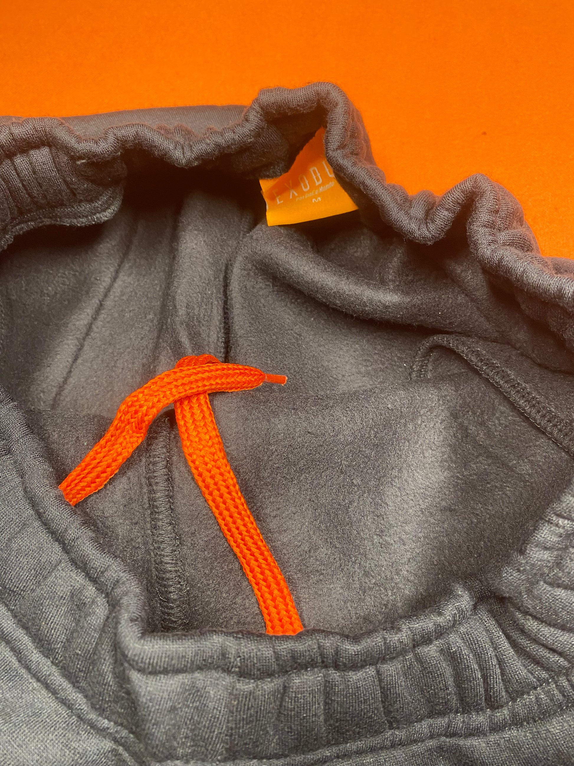 Clothing and accessories from Exodus Pas De Ce Monde – unisex streetwear including t-shirts, jackets, sunglasses, jewelry, bags, and headwear designed for everyday wear and bold urban fashion.
