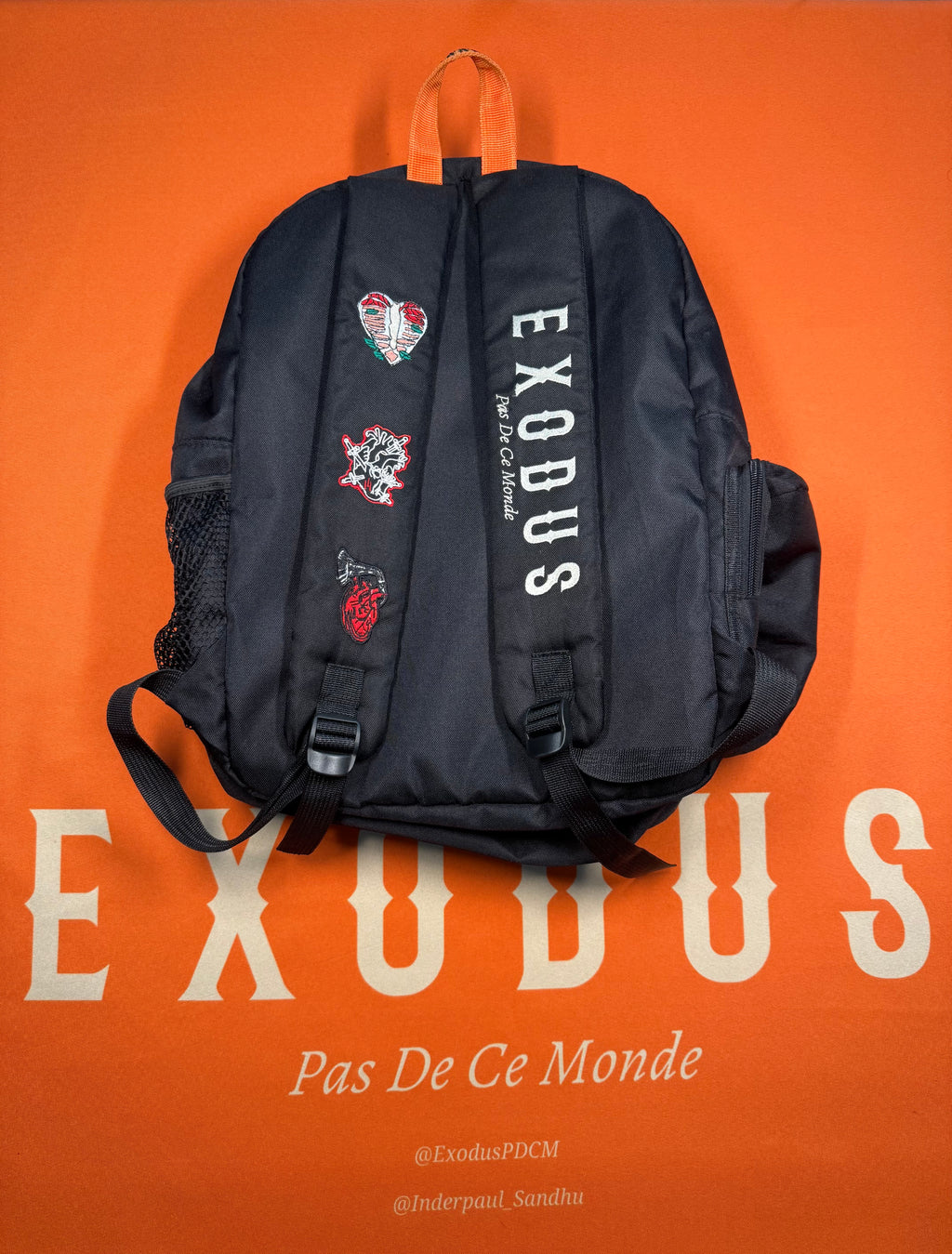 Clothing and accessories from Exodus Pas De Ce Monde – unisex streetwear including t-shirts, jackets, sunglasses, jewelry, bags, and headwear designed for everyday wear and bold urban fashion.