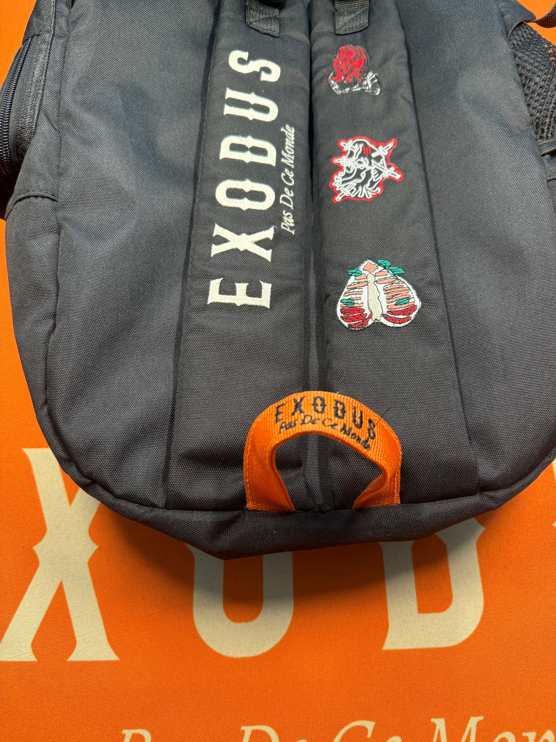 Clothing and accessories from Exodus Pas De Ce Monde – unisex streetwear including t-shirts, jackets, sunglasses, jewelry, bags, and headwear designed for everyday wear and bold urban fashion.