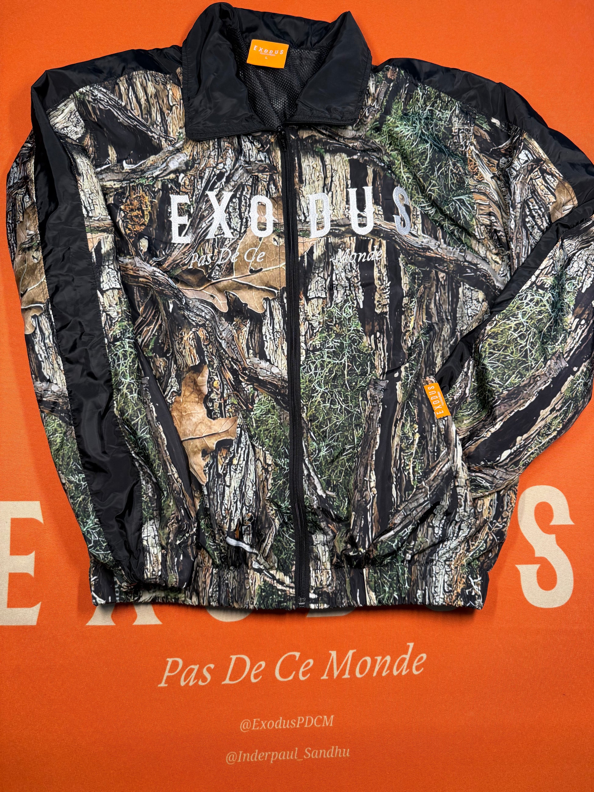 Clothing and accessories from Exodus Pas De Ce Monde – unisex streetwear including t-shirts, jackets, sunglasses, jewelry, bags, and headwear designed for everyday wear and bold urban fashion.