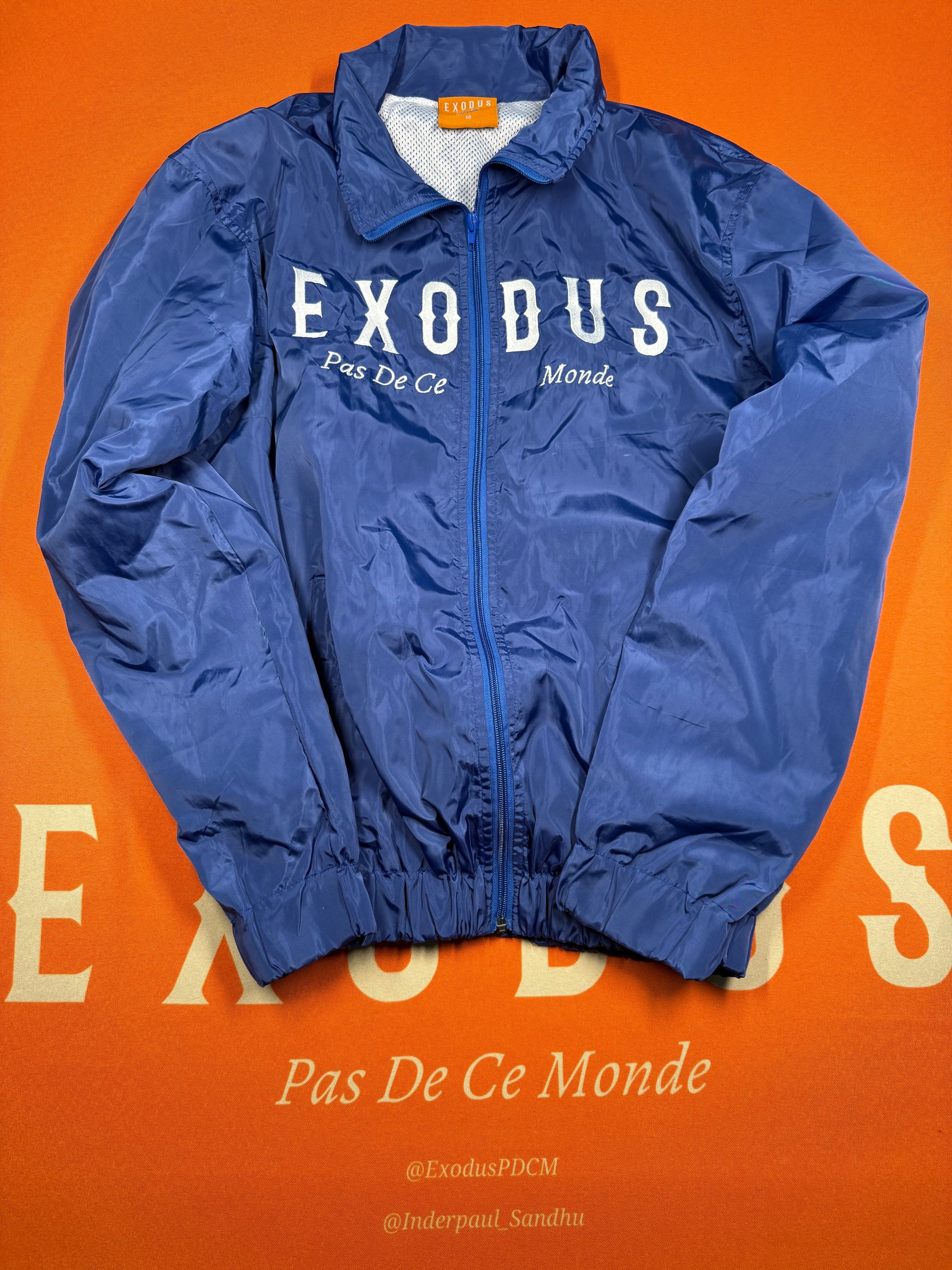 Clothing and accessories from Exodus Pas De Ce Monde – unisex streetwear including t-shirts, jackets, sunglasses, jewelry, bags, and headwear designed for everyday wear and bold urban fashion.