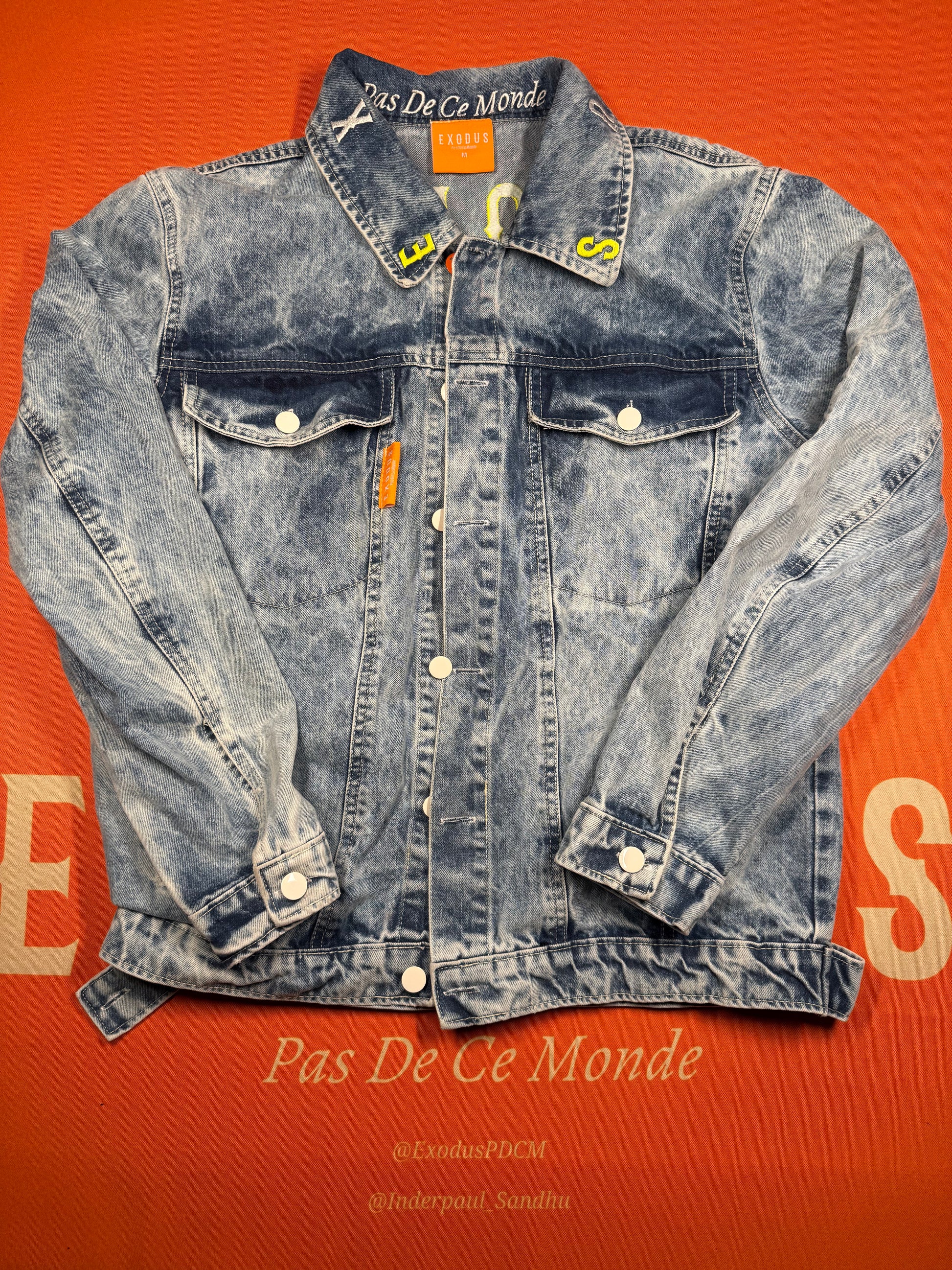 Clothing and accessories from Exodus Pas De Ce Monde – unisex streetwear including t-shirts, jackets, sunglasses, jewelry, bags, and headwear designed for everyday wear and bold urban fashion.