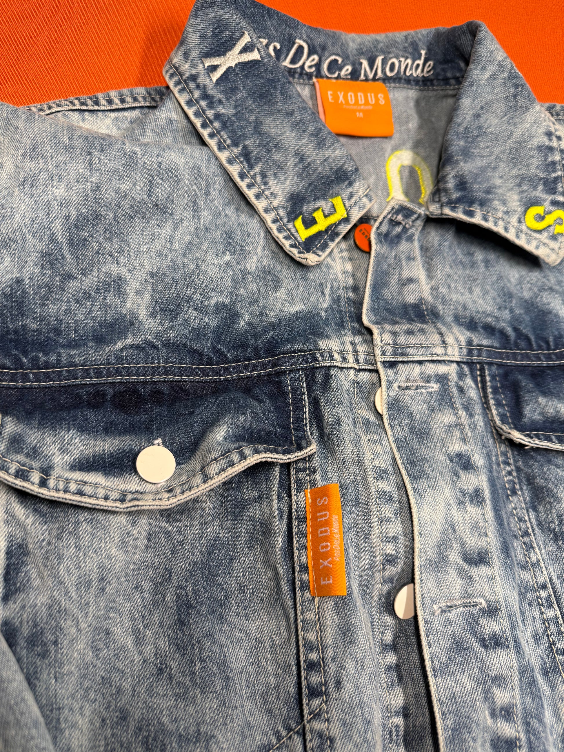 Clothing and accessories from Exodus Pas De Ce Monde – unisex streetwear including t-shirts, jackets, sunglasses, jewelry, bags, and headwear designed for everyday wear and bold urban fashion.