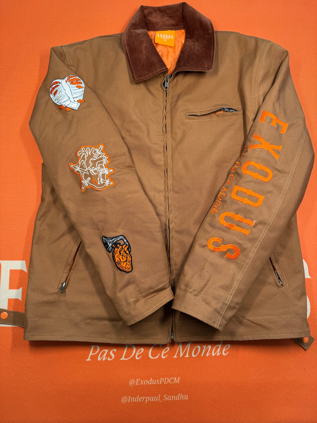 Clothing and accessories from Exodus Pas De Ce Monde – unisex streetwear including t-shirts, jackets, sunglasses, jewelry, bags, and headwear designed for everyday wear and bold urban fashion.