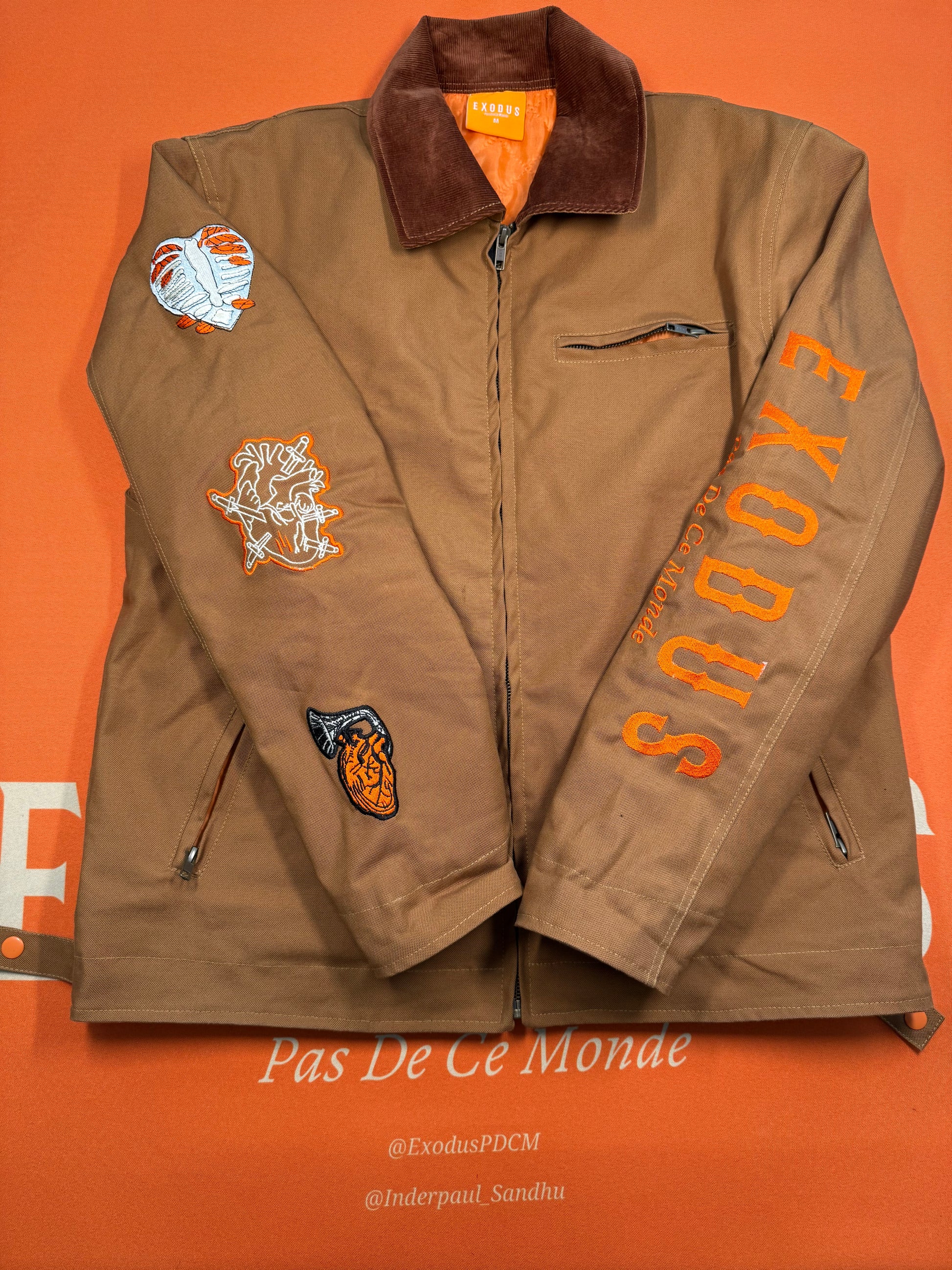 Clothing and accessories from Exodus Pas De Ce Monde – unisex streetwear including t-shirts, jackets, sunglasses, jewelry, bags, and headwear designed for everyday wear and bold urban fashion.