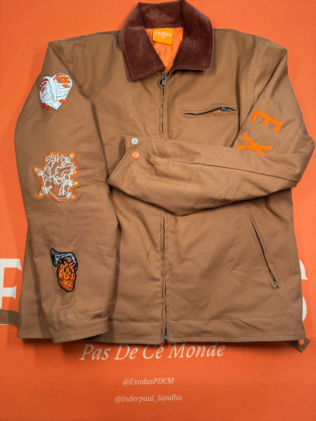 Clothing and accessories from Exodus Pas De Ce Monde – unisex streetwear including t-shirts, jackets, sunglasses, jewelry, bags, and headwear designed for everyday wear and bold urban fashion.