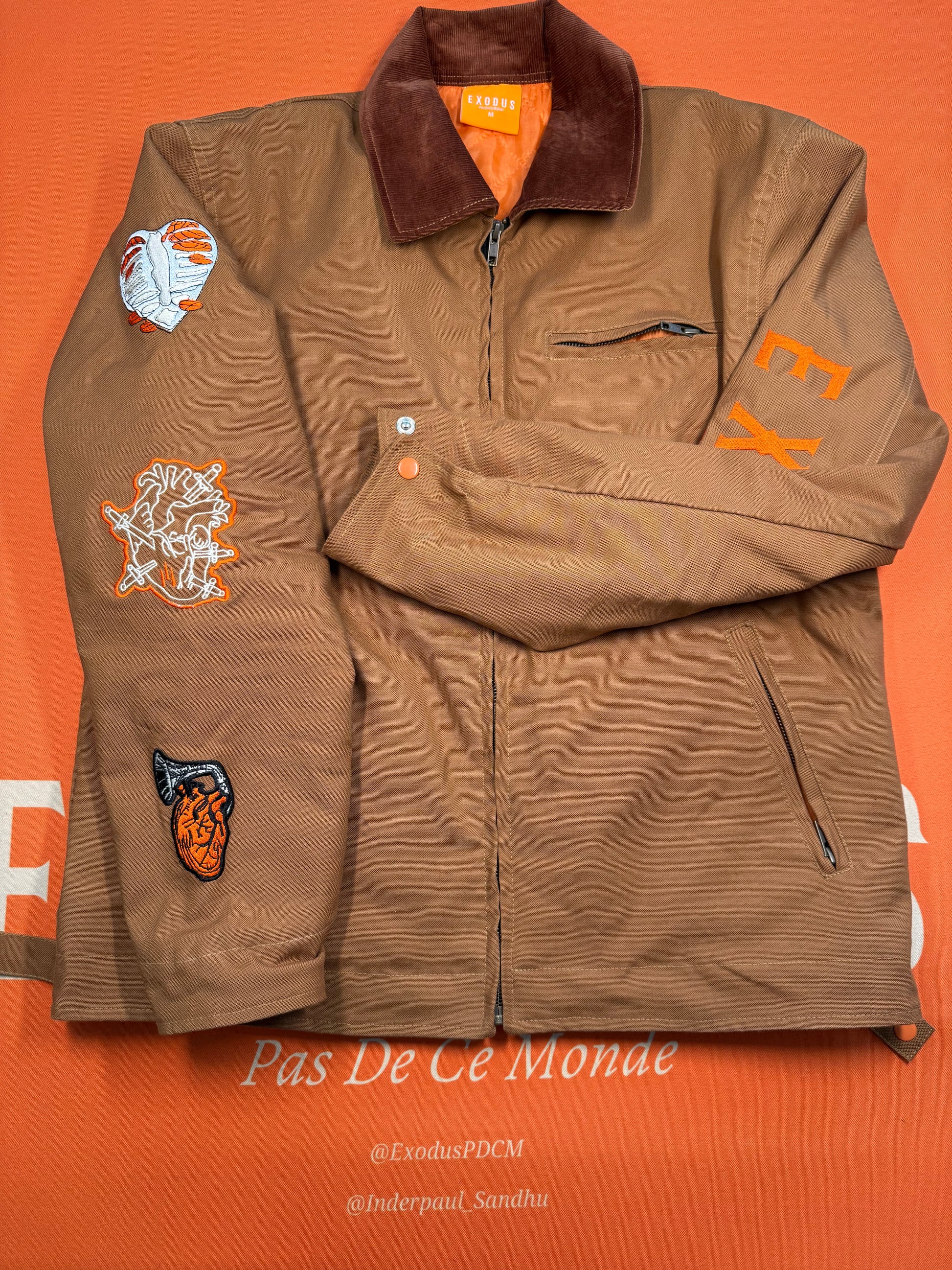 Clothing and accessories from Exodus Pas De Ce Monde – unisex streetwear including t-shirts, jackets, sunglasses, jewelry, bags, and headwear designed for everyday wear and bold urban fashion.