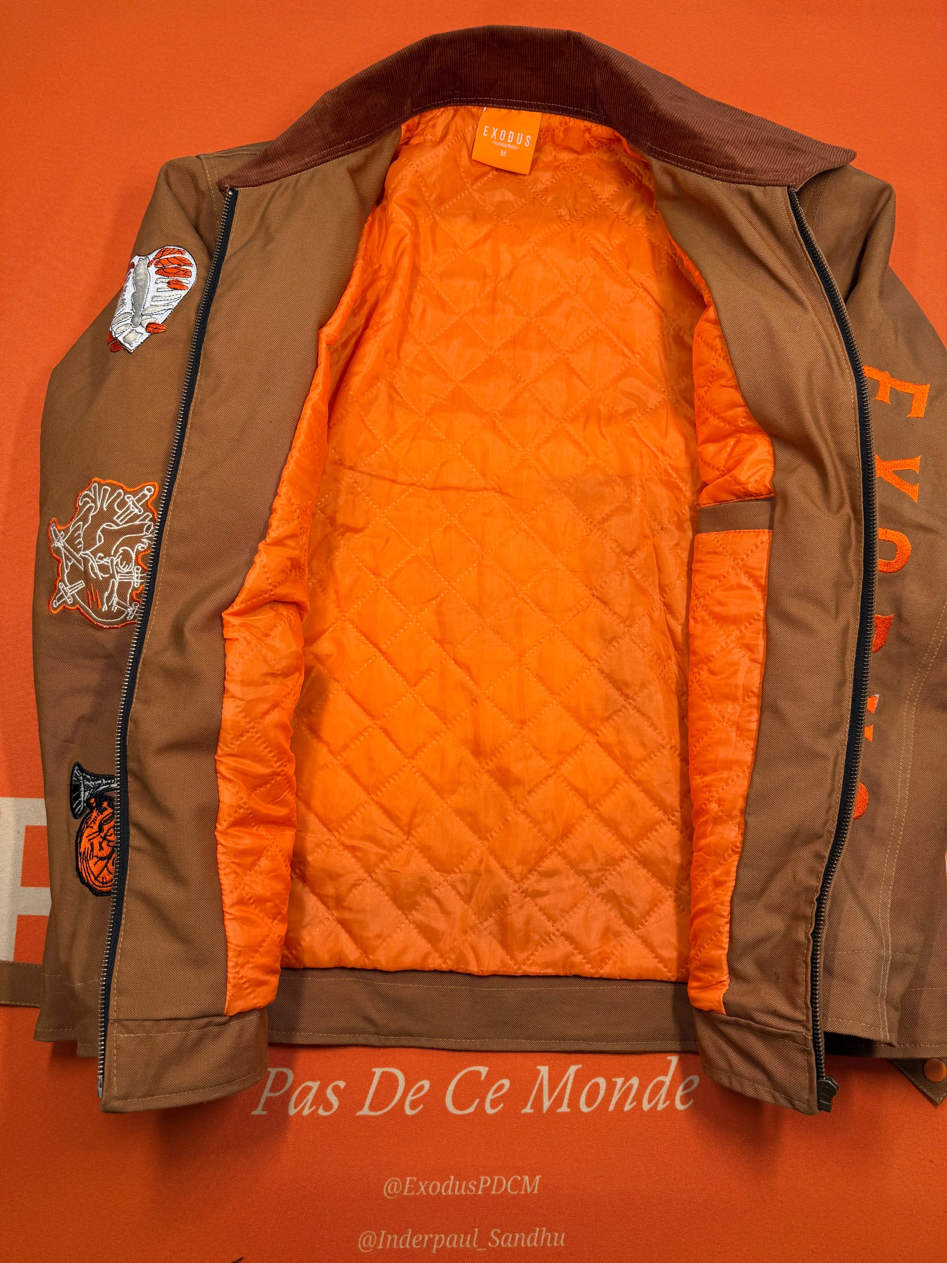Clothing and accessories from Exodus Pas De Ce Monde – unisex streetwear including t-shirts, jackets, sunglasses, jewelry, bags, and headwear designed for everyday wear and bold urban fashion.