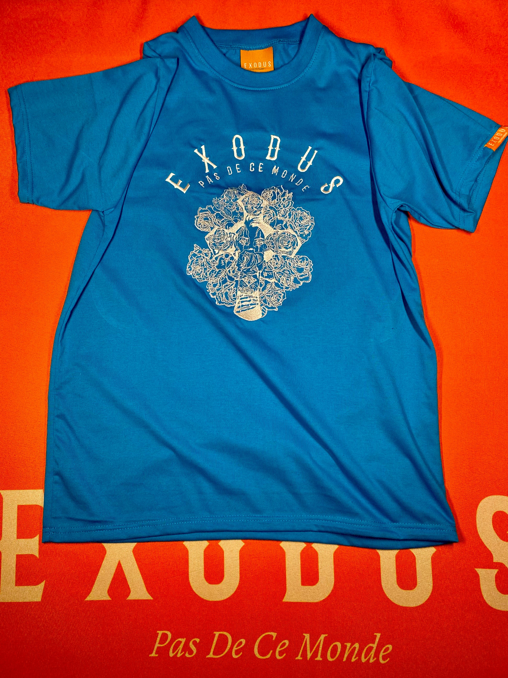 Clothing and accessories from Exodus Pas De Ce Monde – unisex streetwear including t-shirts, jackets, sunglasses, jewelry, bags, and headwear designed for everyday wear and bold urban fashion.