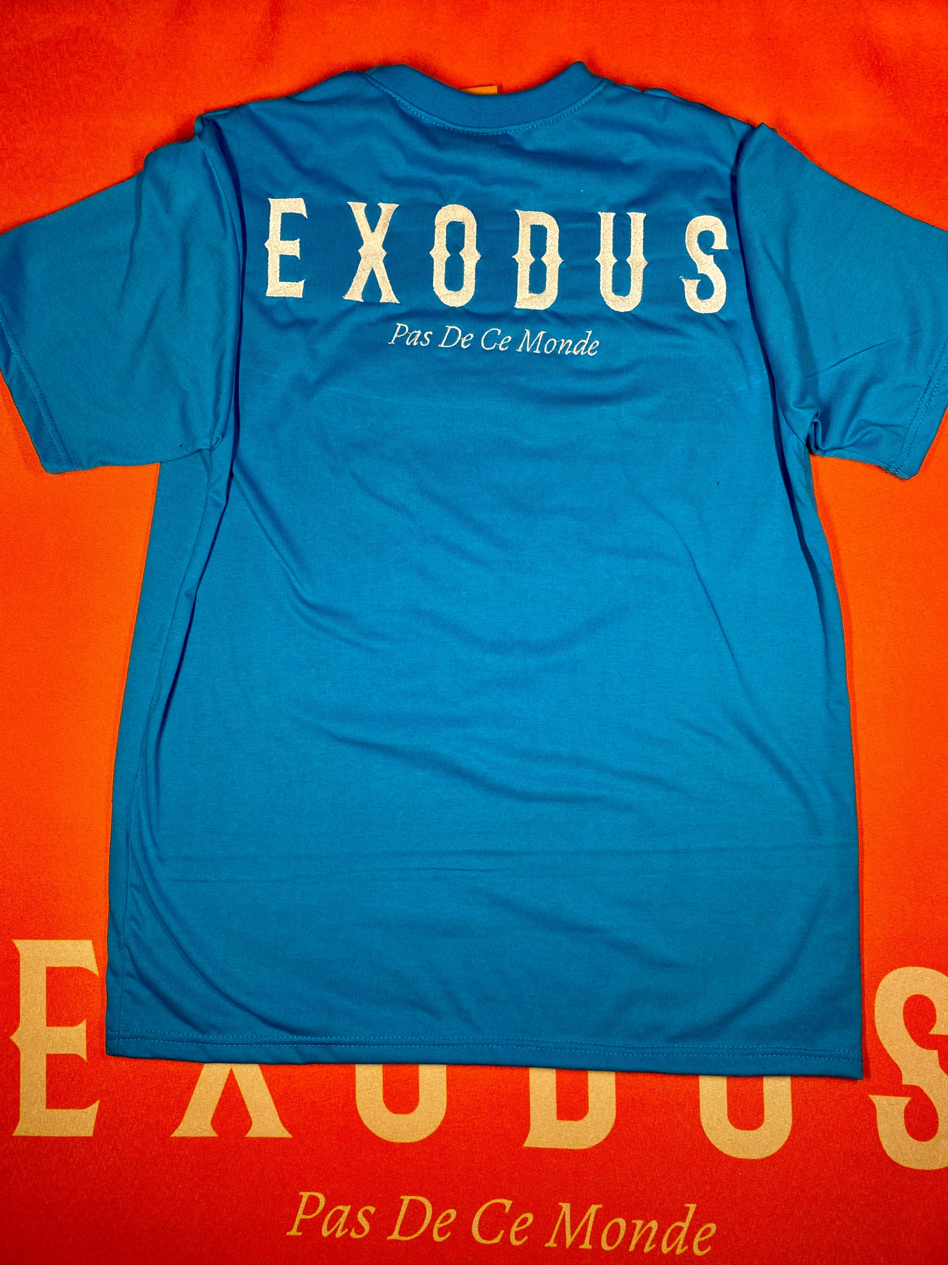 Clothing and accessories from Exodus Pas De Ce Monde – unisex streetwear including t-shirts, jackets, sunglasses, jewelry, bags, and headwear designed for everyday wear and bold urban fashion.