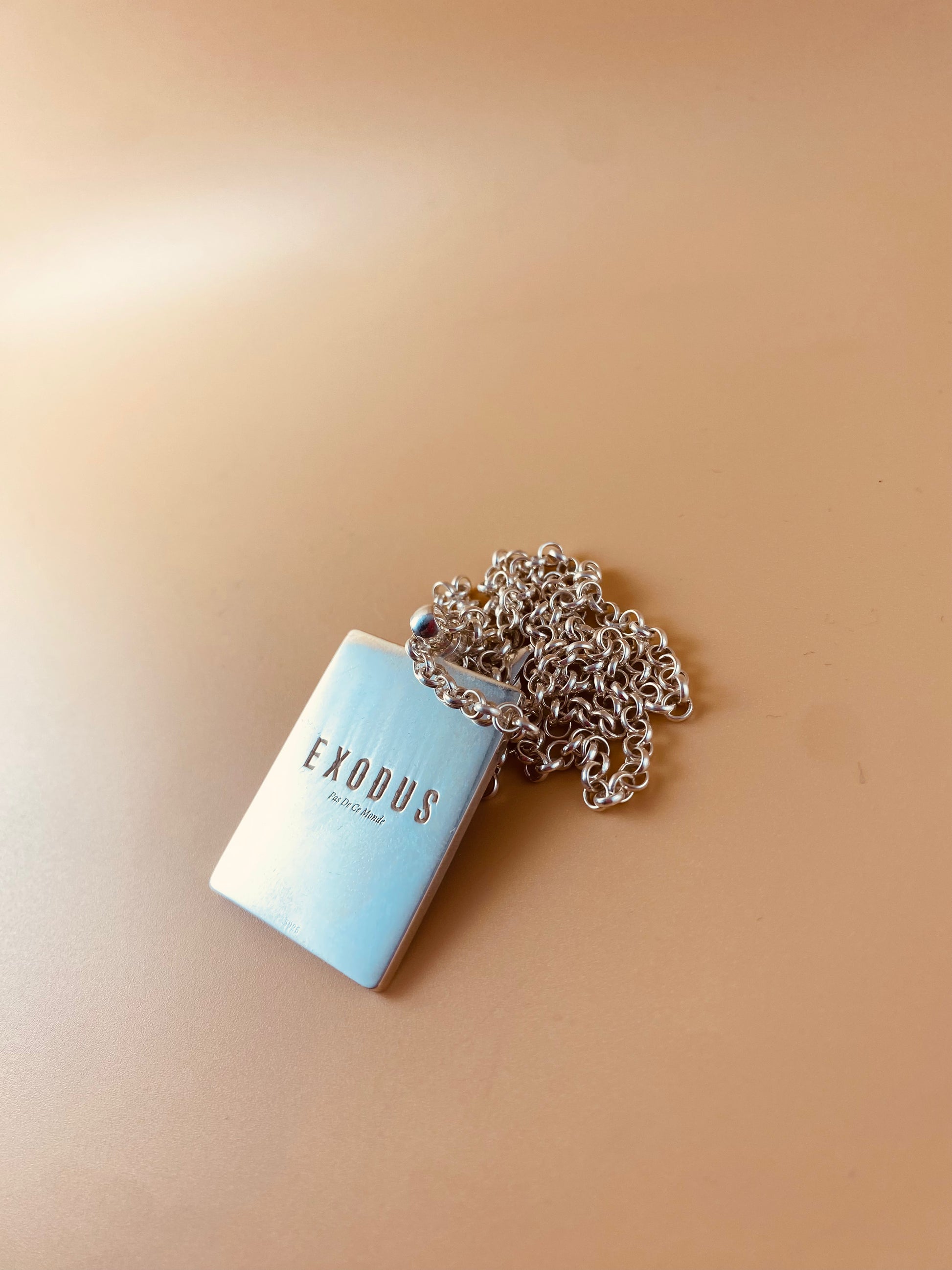 Clothing and accessories from Exodus Pas De Ce Monde – unisex streetwear including t-shirts, jackets, sunglasses, jewelry, bags, and headwear designed for everyday wear and bold urban fashion.
