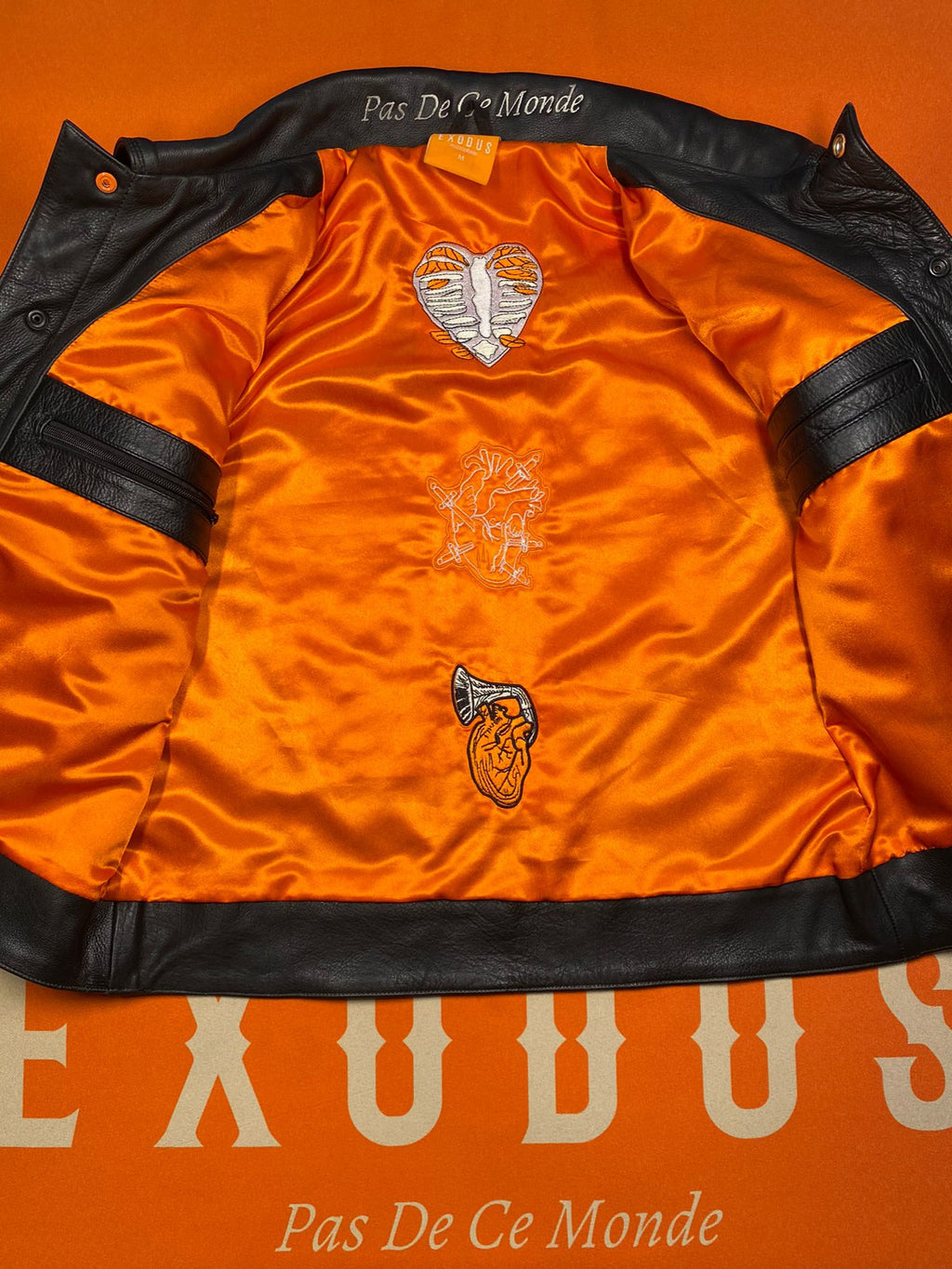 Clothing and accessories from Exodus Pas De Ce Monde – unisex streetwear including t-shirts, jackets, sunglasses, jewelry, bags, and headwear designed for everyday wear and bold urban fashion.