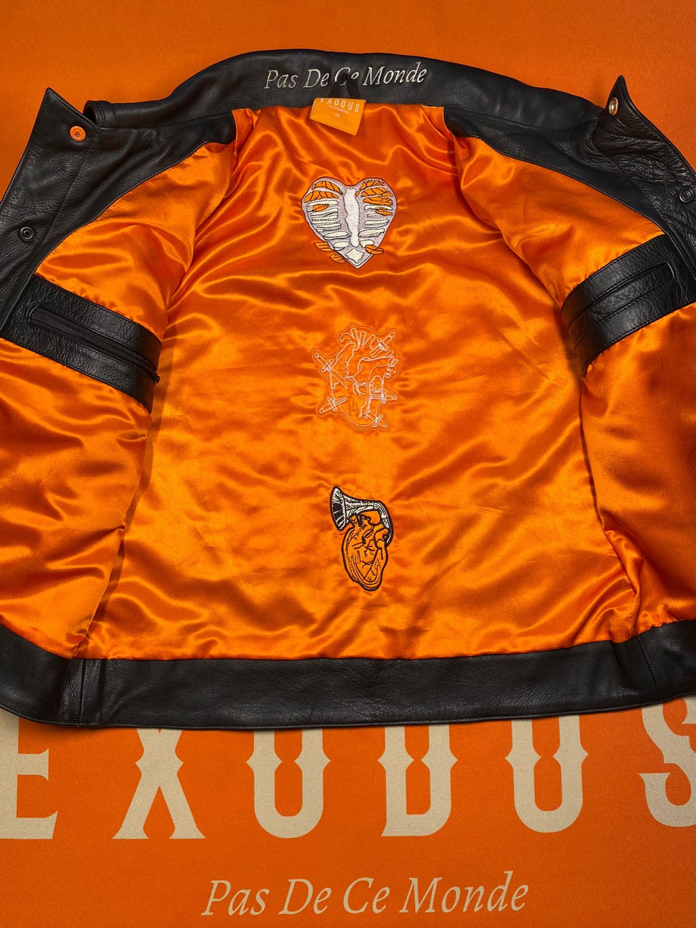 Clothing and accessories from Exodus Pas De Ce Monde – unisex streetwear including t-shirts, jackets, sunglasses, jewelry, bags, and headwear designed for everyday wear and bold urban fashion.