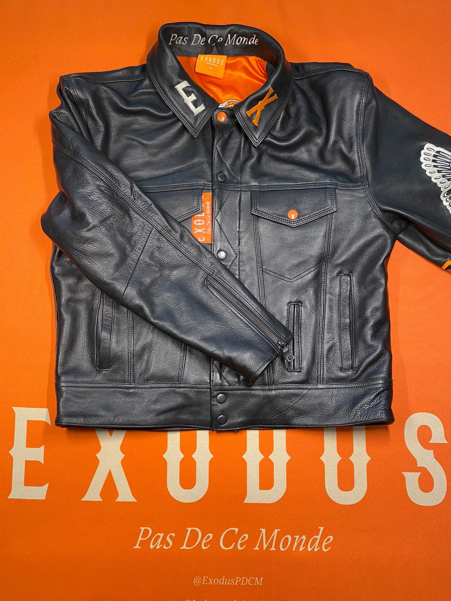 Clothing and accessories from Exodus Pas De Ce Monde – unisex streetwear including t-shirts, jackets, sunglasses, jewelry, bags, and headwear designed for everyday wear and bold urban fashion.