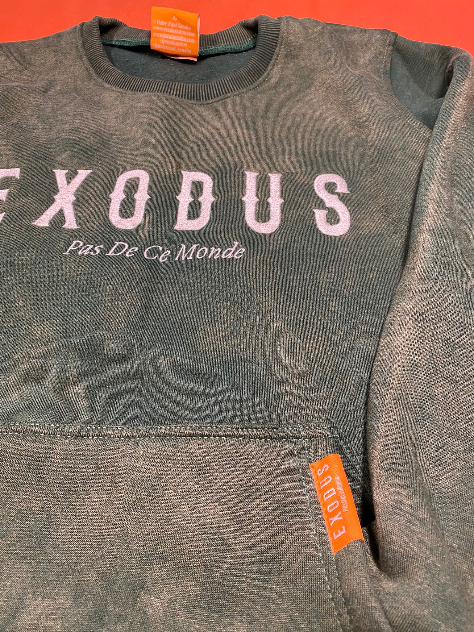 Clothing and accessories from Exodus Pas De Ce Monde – unisex streetwear including t-shirts, jackets, sunglasses, jewelry, bags, and headwear designed for everyday wear and bold urban fashion.