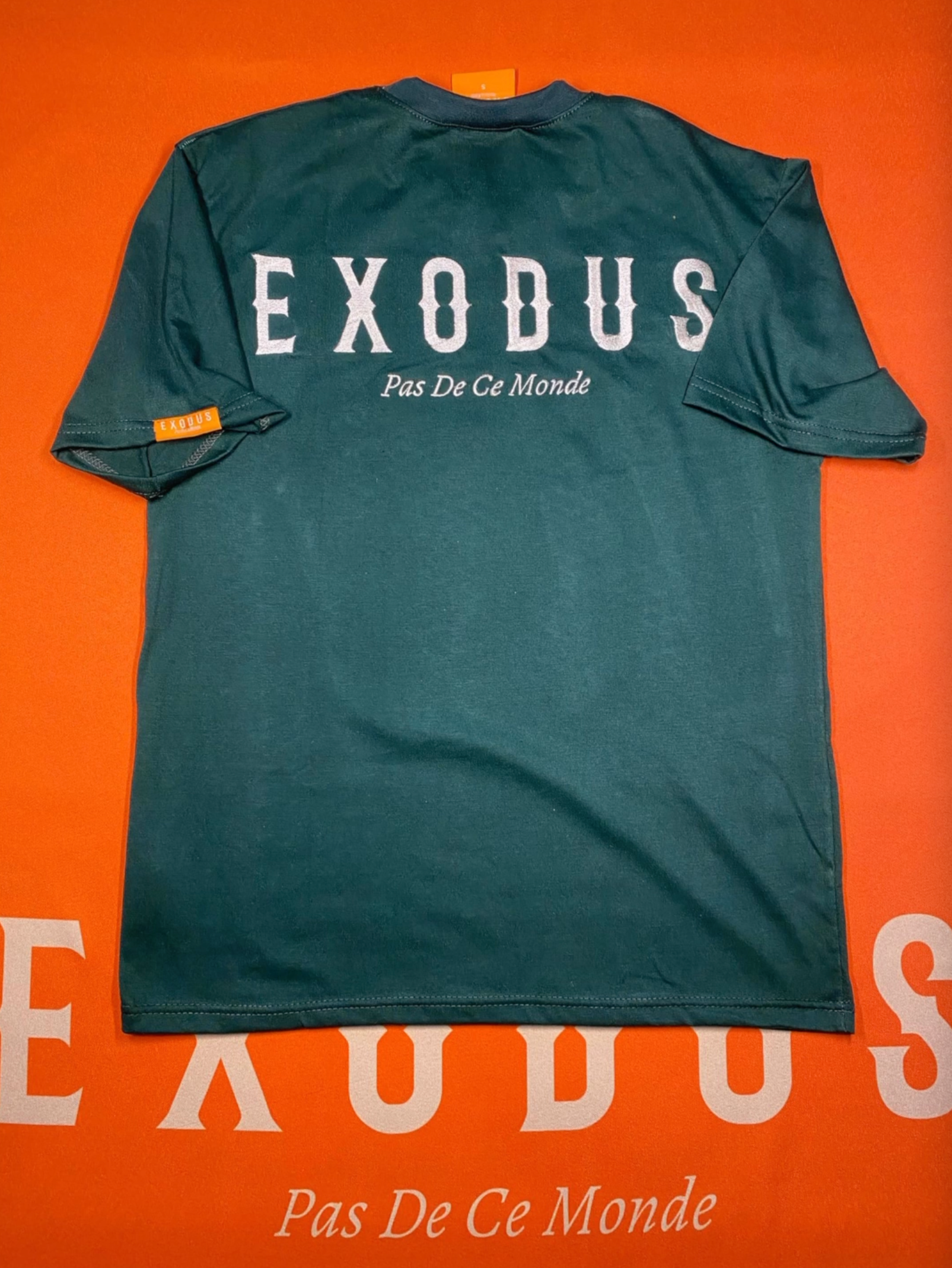Clothing and accessories from Exodus Pas De Ce Monde – unisex streetwear including t-shirts, jackets, sunglasses, jewelry, bags, and headwear designed for everyday wear and bold urban fashion.
