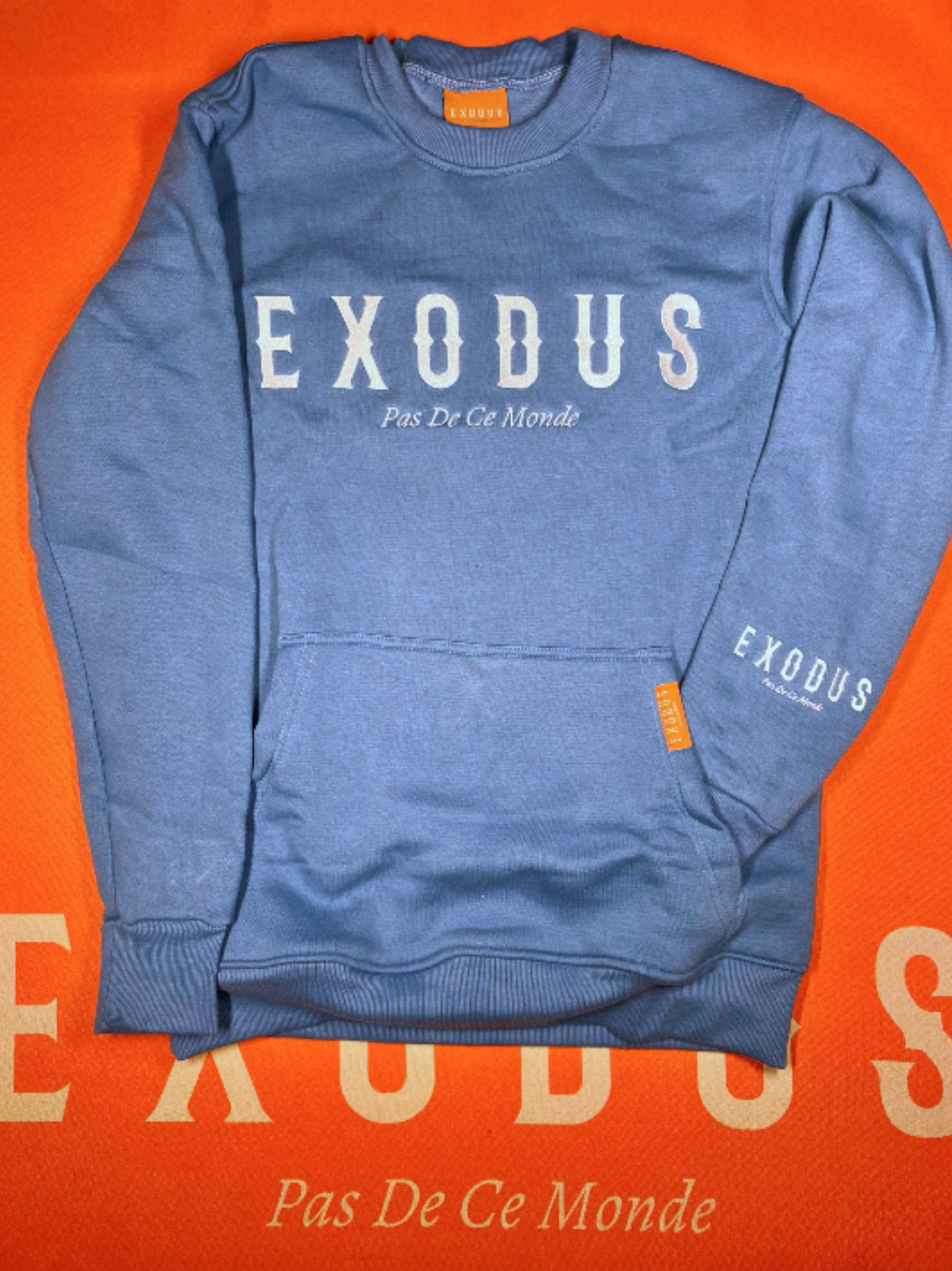 Clothing and accessories from Exodus Pas De Ce Monde – unisex streetwear including t-shirts, jackets, sunglasses, jewelry, bags, and headwear designed for everyday wear and bold urban fashion.